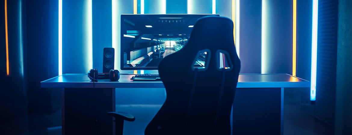 Gamingstol foran en gaming PC med blått backlight